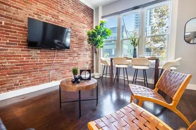 a living room with a brick wall at Gaslamp 2BR Upscale Queen Beds with Smart TV in San Diego