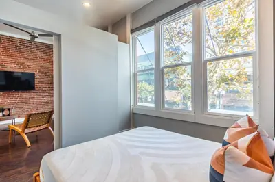 a bedroom with a bed and two windows at Gaslamp 2BR Upscale Queen Beds with Smart TV in San Diego