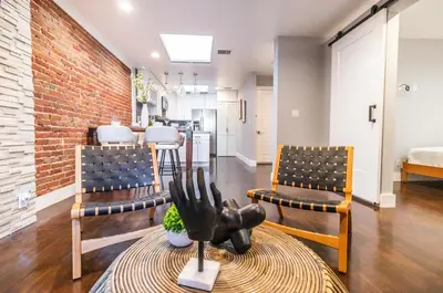 a living room with two chairs and a table at Family-Friendly Apartment with Kitchen in San Diego
