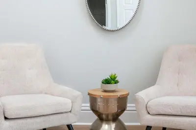 two chairs and a table with a mirror in a room at Gaslamp Loft Escape Sleeps 7 in Style in San Diego