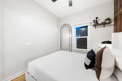 a white bedroom with a white bed and a window at Relax in Stylish 1BR Near Gaslamp and Little Italy in San Diego