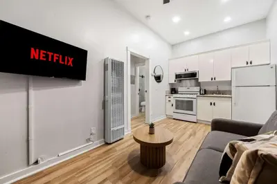a living room with a couch and a kitchen at Relax in Stylish 1BR Near Gaslamp and Little Italy in San Diego