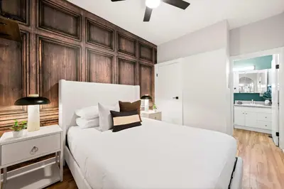 a bedroom with a white bed and wooden walls at Relax in Stylish 1BR Near Gaslamp and Little Italy in San Diego