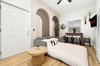 a white bedroom with a bed and a table at Relax in Stylish 1BR Near Gaslamp and Little Italy in San Diego