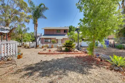 a house with a fence and a yard at 4 Mi to Lake Elsinore Pet-Friendly Adventure Base in Lake Elsinore