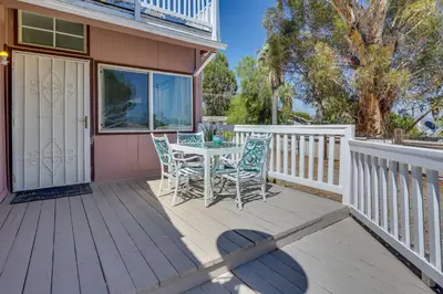 a wooden deck with a table and chairs on it at Lake Elsinore Apt 4 Mi to Water Pets Welcome! in Lake Elsinore