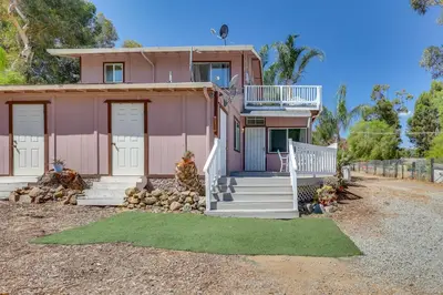 a pink house with white doors and a porch at Lake Elsinore Apt 4 Mi to Water Pets Welcome! in Lake Elsinore