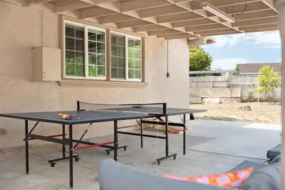 a ping pong table in front of a house at Near Safari & Beach - Backyard Games - AC - Pet OK in Escondido
