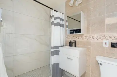 a bathroom with a shower and a toilet and a sink at Near Safari & Beach - Backyard Games - AC - Pet OK in Escondido