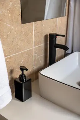 a bathroom with a sink and a black soap dispenser at Near Safari & Beach - Backyard Games - AC - Pet OK in Escondido