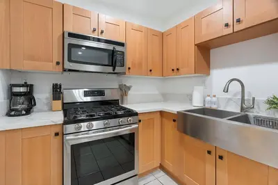 a kitchen with a stove and a microwave at Casita Full Kitchen-AC-Ping Pong in Escondido