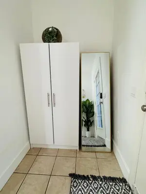 a room with a mirror and a white cabinet at Casita Full Kitchen-AC-Ping Pong in Escondido