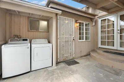a washer and dryer sitting outside of a house at Casita Full Kitchen-AC-Ping Pong in Escondido