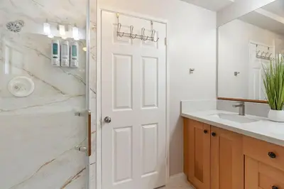 a white bathroom with a sink and a shower at Casita Full Kitchen-AC-Ping Pong in Escondido