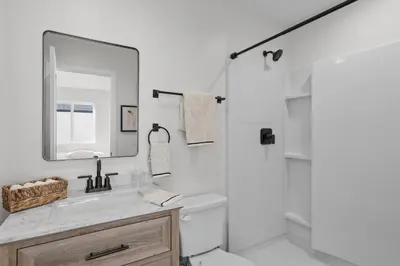 a white bathroom with a sink and a mirror at Modern Organic Getaway - New 2 Bed 2 Bath - Close to Beaches & Downtown in San Diego