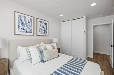 a bedroom with a bed with blue and white pillows at Modern Organic Getaway - New 2 Bed 2 Bath - Close to Beaches & Downtown in San Diego