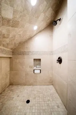 a bathroom with a shower with a tiled floor at Majestic Corner Coastal Haven in San Diego