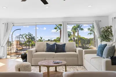 a living room with a couch and a table at PB Ocean Views - Garage, Parking, King Bed in San Diego