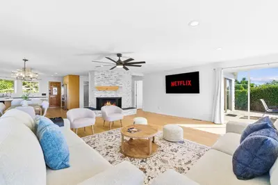a living room with a white couch and a fireplace at PB Ocean Views - Garage, Parking, King Bed in San Diego