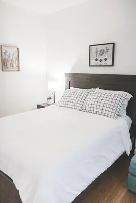a bedroom with a white bed with two pictures on the wall at Mira Mesa Private Suite with Private Bath & Entry #2 in San Diego