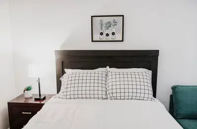 a bedroom with a white bed with a wooden headboard at Mira Mesa Private Suite with Private Bath & Entry #2 in San Diego