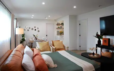 a living room with a bed and a dining room at NEW! Hot TubPoolFire Pit10 Mins to Beach in San Diego