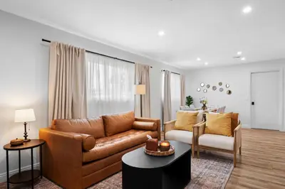 a living room with a leather couch and a chair at NEW! Hot TubPoolFire Pit10 Mins to Beach in San Diego