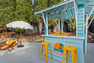 a bar with two yellow stools and an umbrella at NEW! Hot TubPoolFire Pit10 Mins to Beach in San Diego