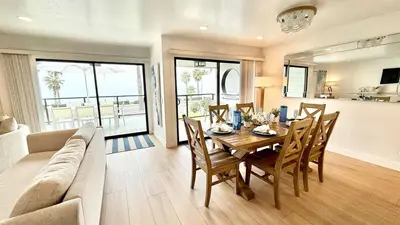 a dining room with a table and a couch at Location! Location! Location! Walk Everywhere! in Oceanside