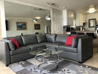 a living room with a couch and a glass table at Ocean Front On Beach! -2 Master BR, 2 Full BA, Patio!, AC, Parking, Close to All in San Diego