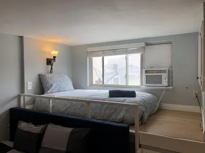 a bedroom with a bunk bed and a microwave at Ocean Front Beauty right on Best Beach in Mission Beach, San Diego! in San Diego