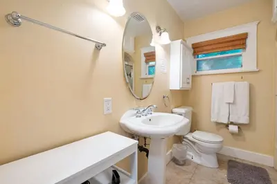 a bathroom with a sink and a toilet and a mirror at La Jolla Village Escape - Walk to Everything in San Diego