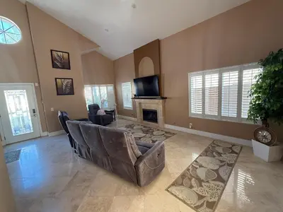 a living room with a couch and a fireplace at South OC House in Laguna Niguel