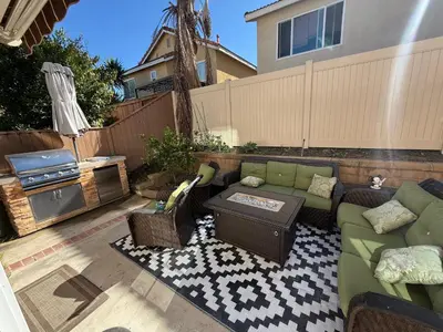 a patio with a couch and a table at South OC House in Laguna Niguel