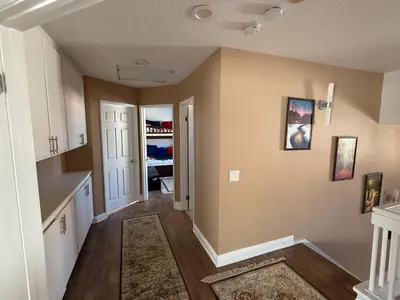 an empty room with a kitchen and a hallway at South OC House in Laguna Niguel