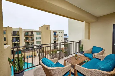 a balcony with chairs and a table on a balcony at SeaCliff Costa Pacifica -1310 in Oceanside