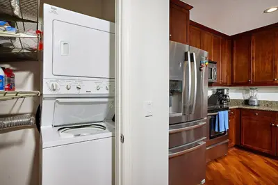 a kitchen with white appliances and wooden cabinets at SeaCliff Costa Pacifica -1310 in Oceanside