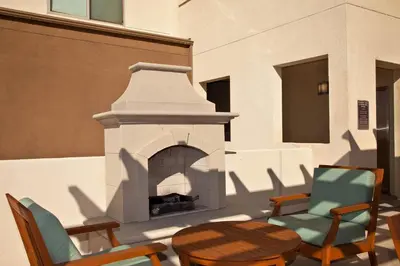 a patio with a fireplace and chairs and a table at SeaCliff Costa Pacifica -1310 in Oceanside