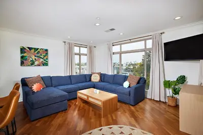 a living room with a blue couch and a table at SeaCliff Costa Pacifica -1310 in Oceanside
