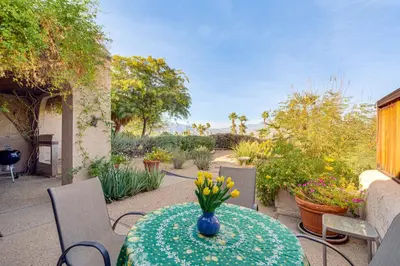 a table with a vase of flowers on a patio at Pool and Tennis Court Access Borrego Springs Condo in Borrego Springs