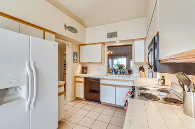 a kitchen with white appliances and white cabinets at Pool and Tennis Court Access Borrego Springs Condo in Borrego Springs