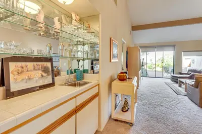 a kitchen with a sink and a living room at Pool and Tennis Court Access Borrego Springs Condo in Borrego Springs