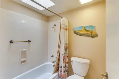 a bathroom with a toilet and a bath tub at Pool and Tennis Court Access Borrego Springs Condo in Borrego Springs