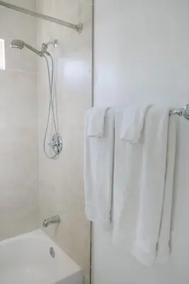 a bathroom with white towels hanging from a shower at Mira Mesa Private Suite with Private Bath & Entry #1 in San Diego