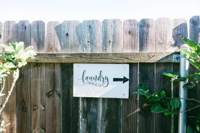 a sign that says laundry on a wooden fence at Mira Mesa Private Suite with Private Bath & Entry #1 in San Diego