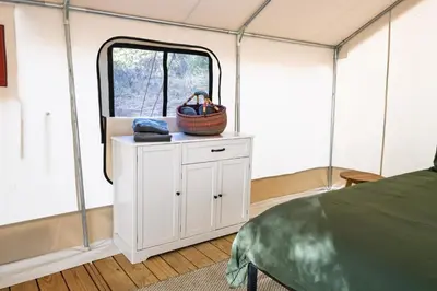 a room with a bed and a window in a tent at Peaceful Mountain Tent Escape at Harrison Ranch in Pauma Valley