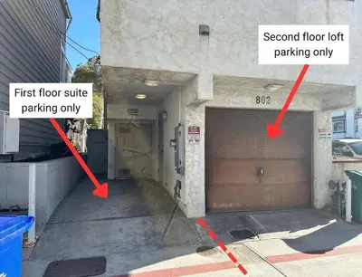 a garage door with two arrow signs on it at Mission Beach Loft Garage Steps 2 Ocean in San Diego