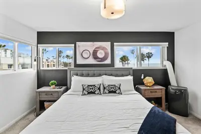 a bedroom with a large bed with two night stands at Ocean front luxury condo with sunset views in San Diego
