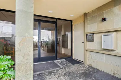 an entrance to a building with a sliding glass door at Ocean front luxury condo with sunset views in San Diego