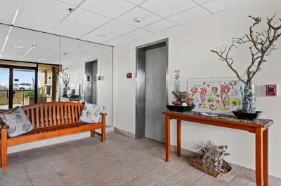 a room with a wooden bench and a table at Ocean front luxury condo with sunset views in San Diego
